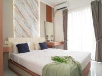 Bright and Homey Studio Room at Apartment Sky House BSD By Travelio