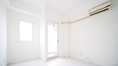 Cozy Living Studio Unfurnished with AC at Puncak Dharmahusada Apartment By Travelio