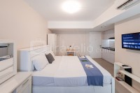 Minimalist Studio Room at Urbantown Serpong Apartment By Travelio
