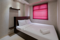 Homey and Relaxing 2BR Green Pramuka City Apartment By Travelio