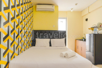 Yellow Accent Wall Studio Apartment at Bassura City By Travelio