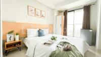 White Brown Studio at Daan Mogot City Apartment By Travelio