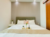 Restful Wooden Touch Studio at Apartment Grand Kamala Lagoon By Travelio